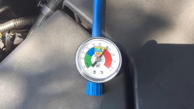 a pressure gauge connected to a vehicle's air conditioning system