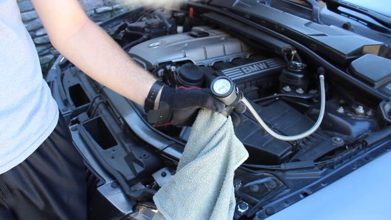 A person working on a car's air conditioning system