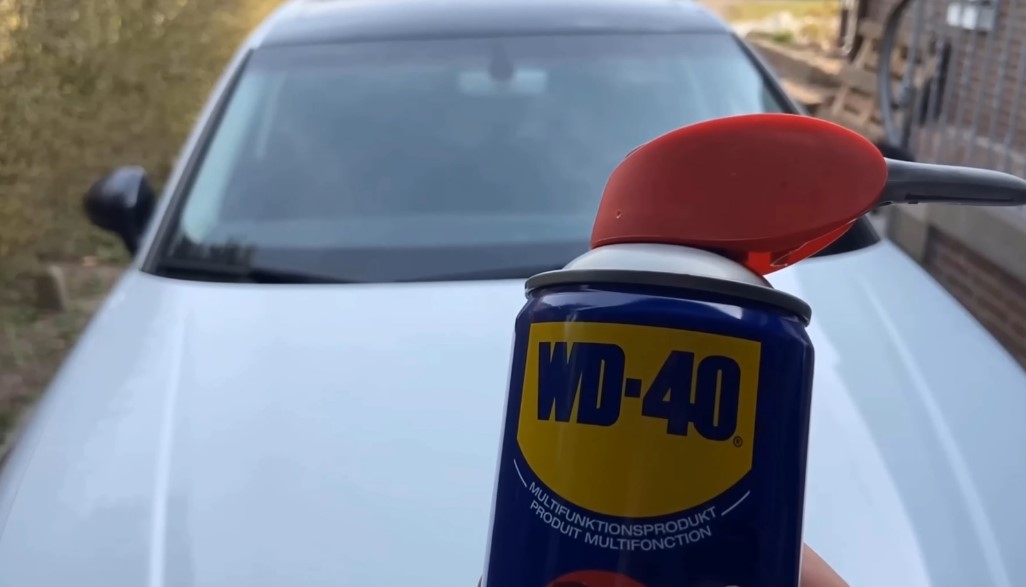 bottle of WD-40 while car is behind in the second plan