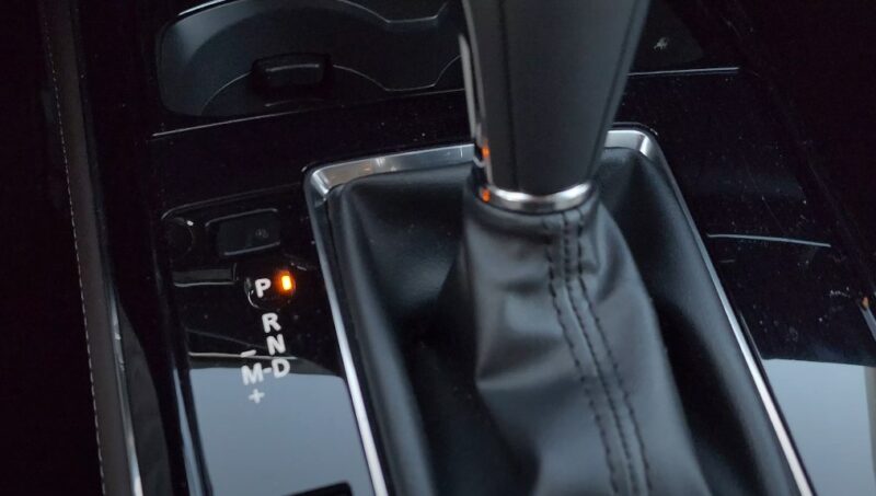 Car interior showing a close up of a gear shifter