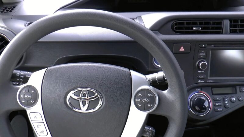 The image shows the interior dashboard of a Toyota Prius C 3