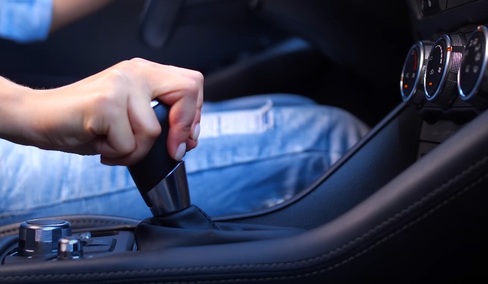 Woman's hand holding manual gear shifter