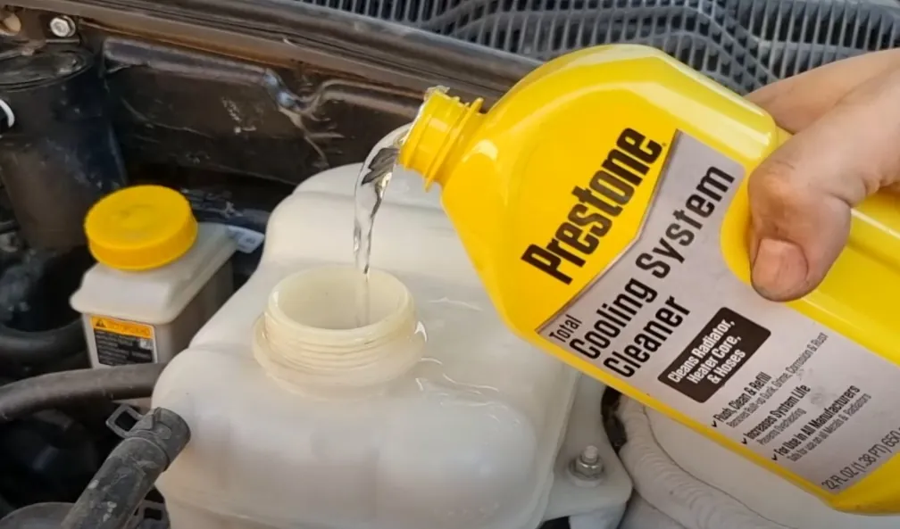 Pouring coolant into car reservoir