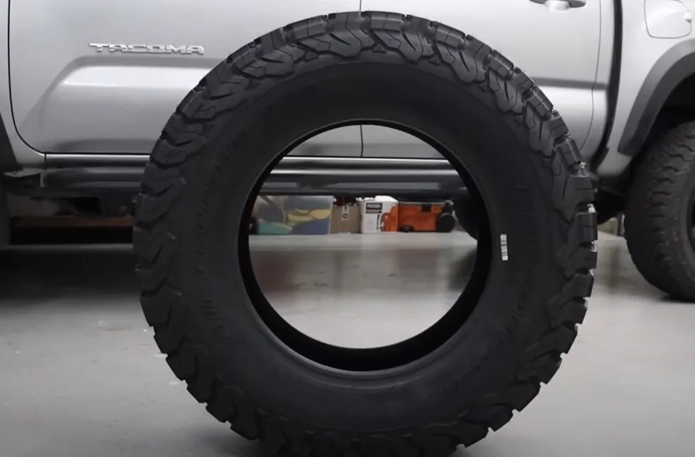 Photo of a tire on the floor, in the shop