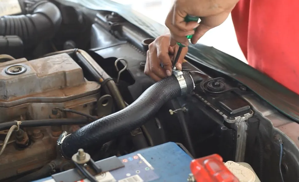 Mechanic repairing clogged radiator in a car