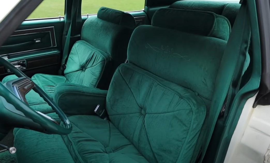 Green interior showing front seats and seatbelt