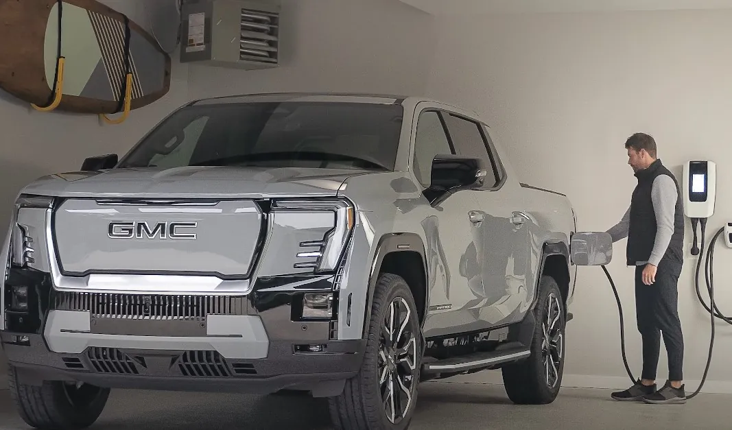 Man charging Sierra EV truck at home