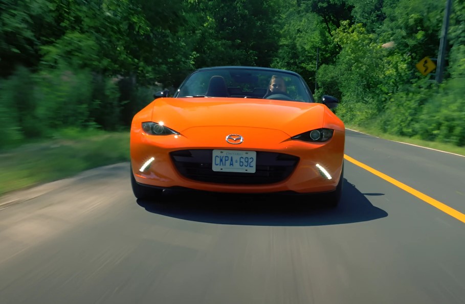 Orange Mazda MX-5 Miata on the road