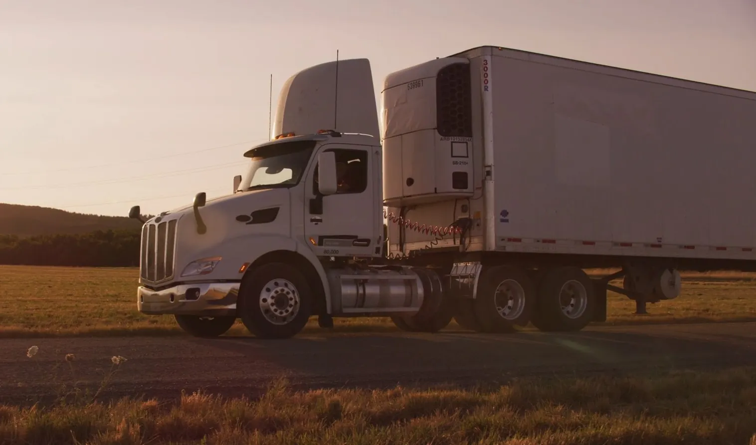 White truck on the road during a beautiful sunset