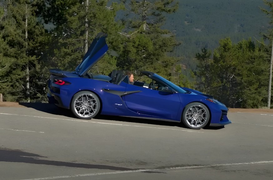 Blue Corvette convertible parked next to road