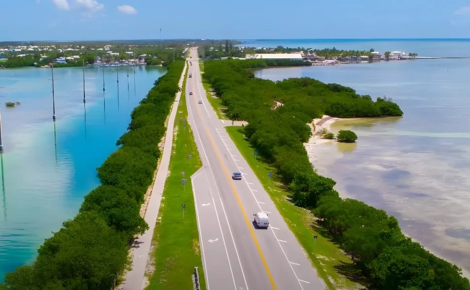 Drone shot of a road in Florida surrounded by water