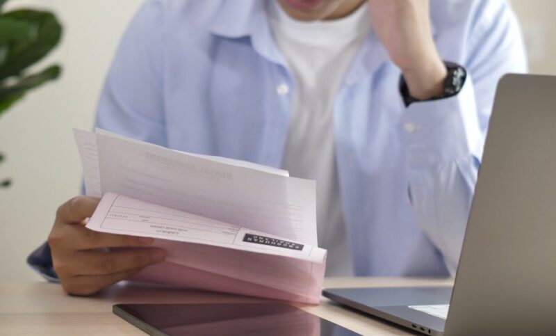 Person reviewing car registration documents at a desk