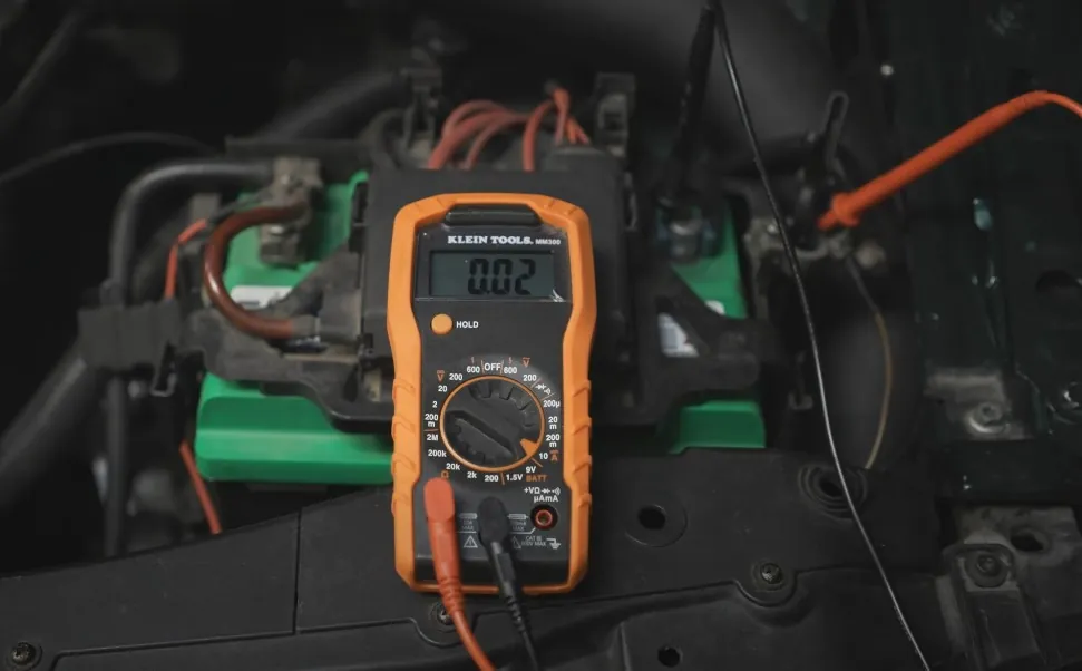 Multimeter connected to a car battery