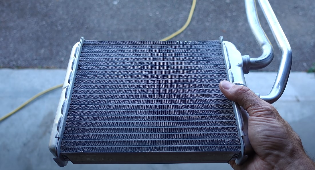 Mechanic holds cleaned heater core