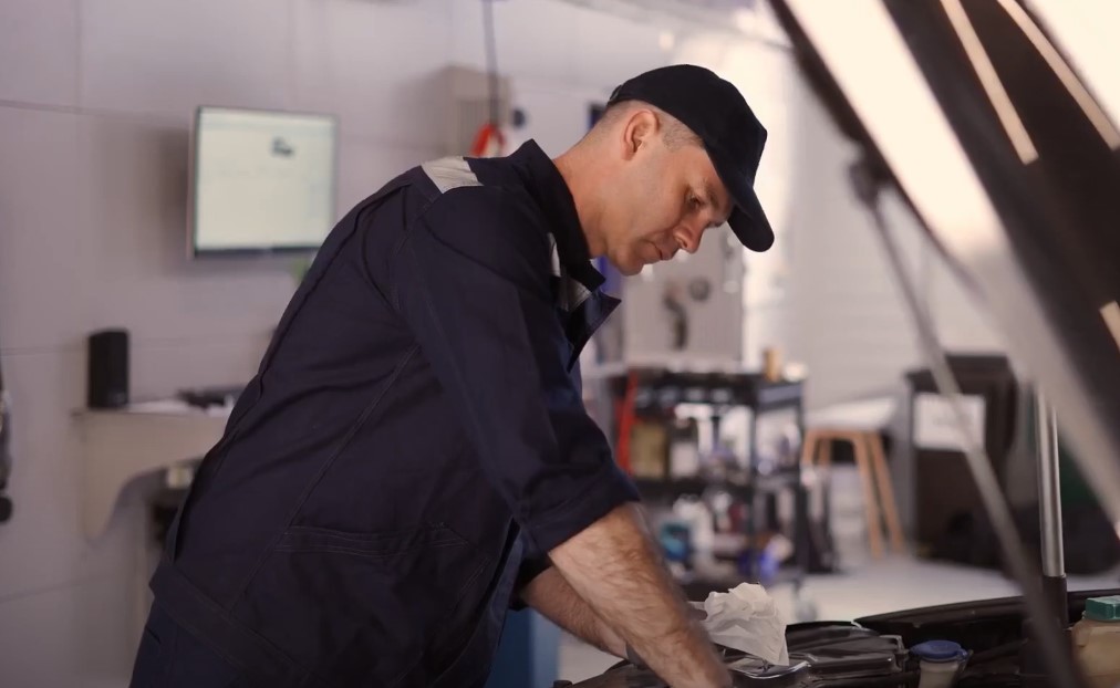 Focused mechanic working on car