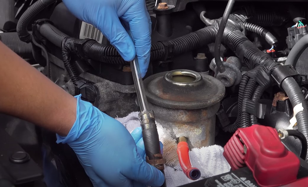 Mechanic fixing power steering fluid leaks