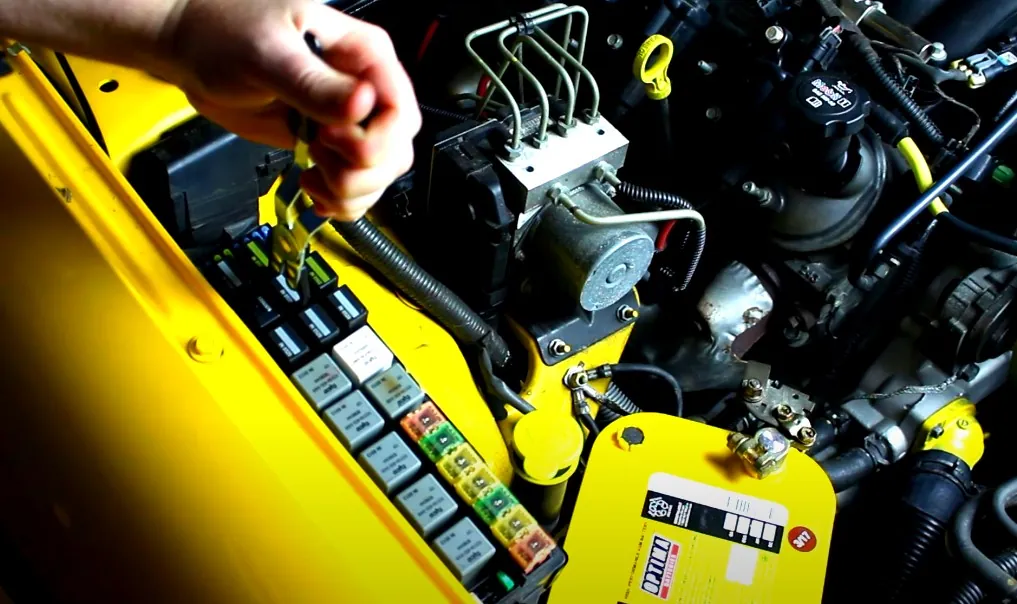 Close up photo of a car fuse box under the hood