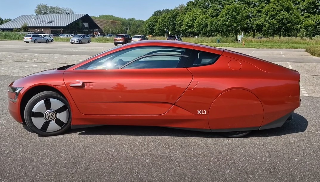 Red VW XL1 at a parking lot