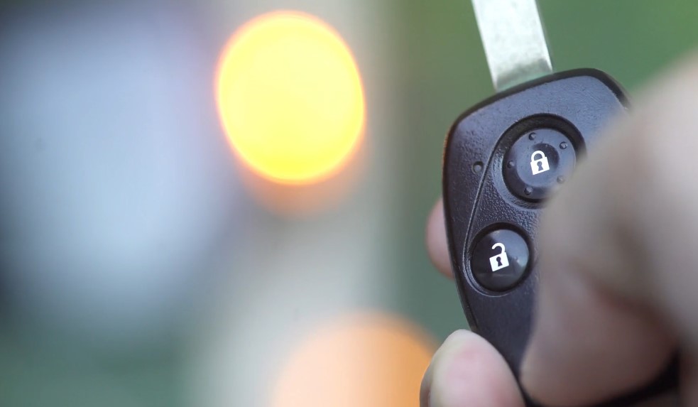 Close up view of a person holding car keys in a hand