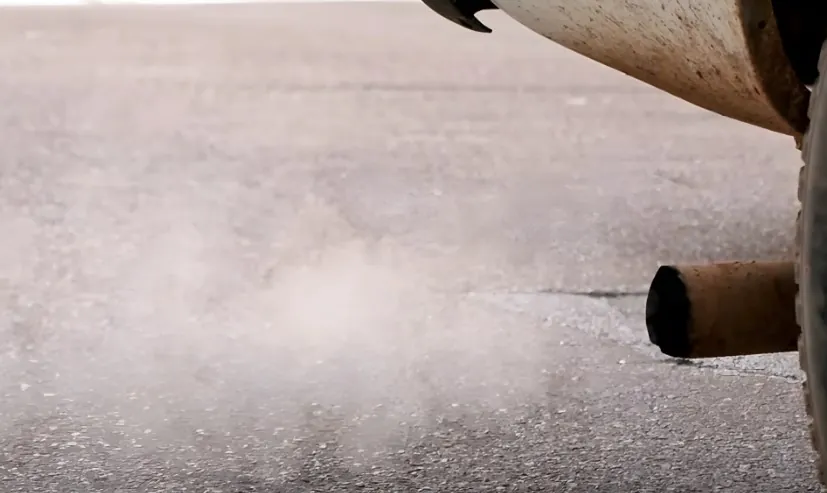 White smoke coming out from a car's exhaust, close up