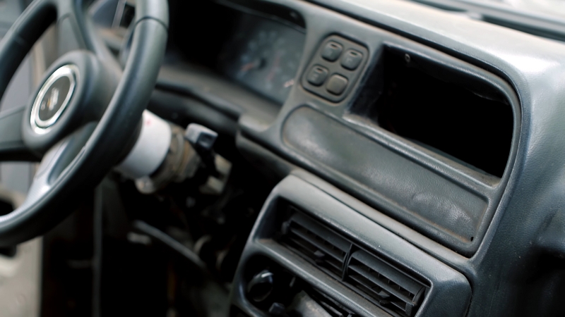 Interior of An Old Car with A Worn-Out Dashboard and Steering Wheel