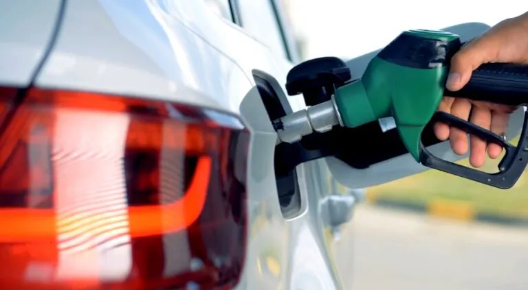 Fueling up a white car at a gas station