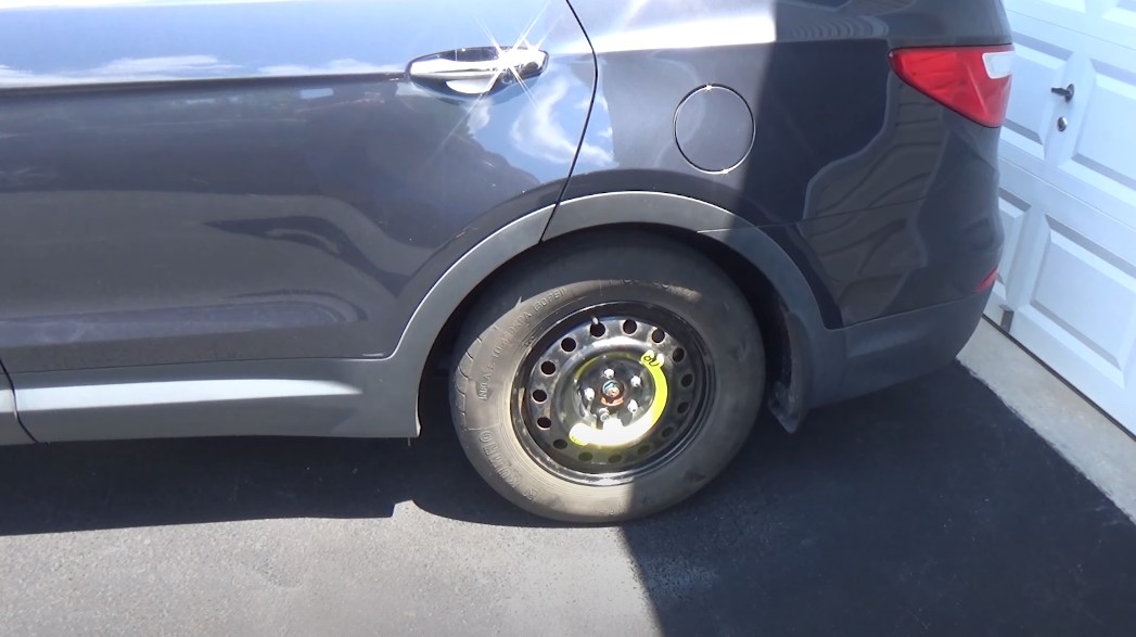 Spare tire mounted on a dark gray car