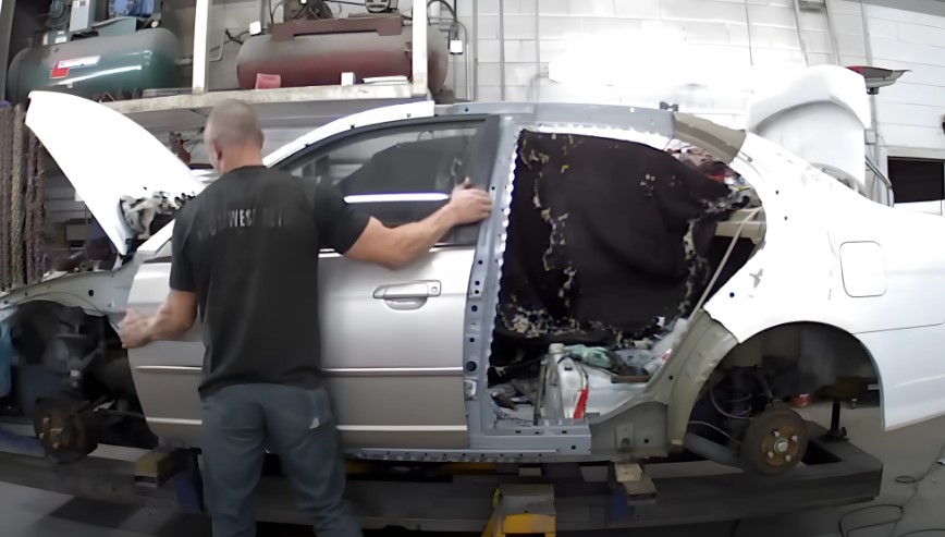 A car body undergoes meticulous repair