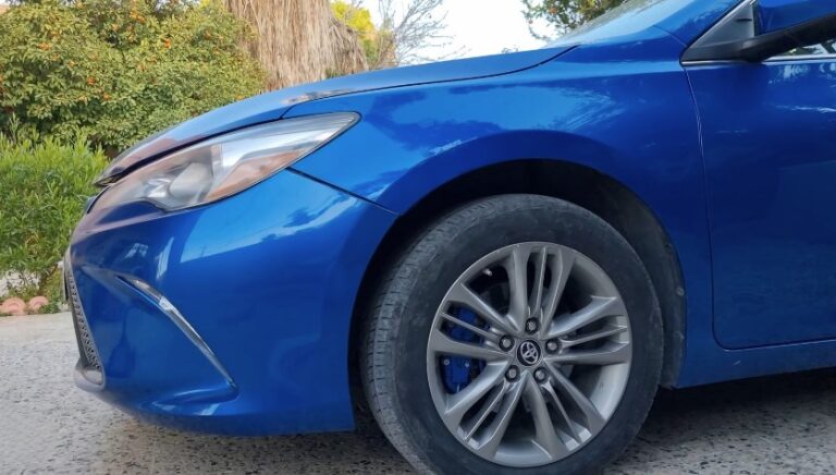 Vibrant blue sedan, showcasing a sleek profile and stylish alloy wheels