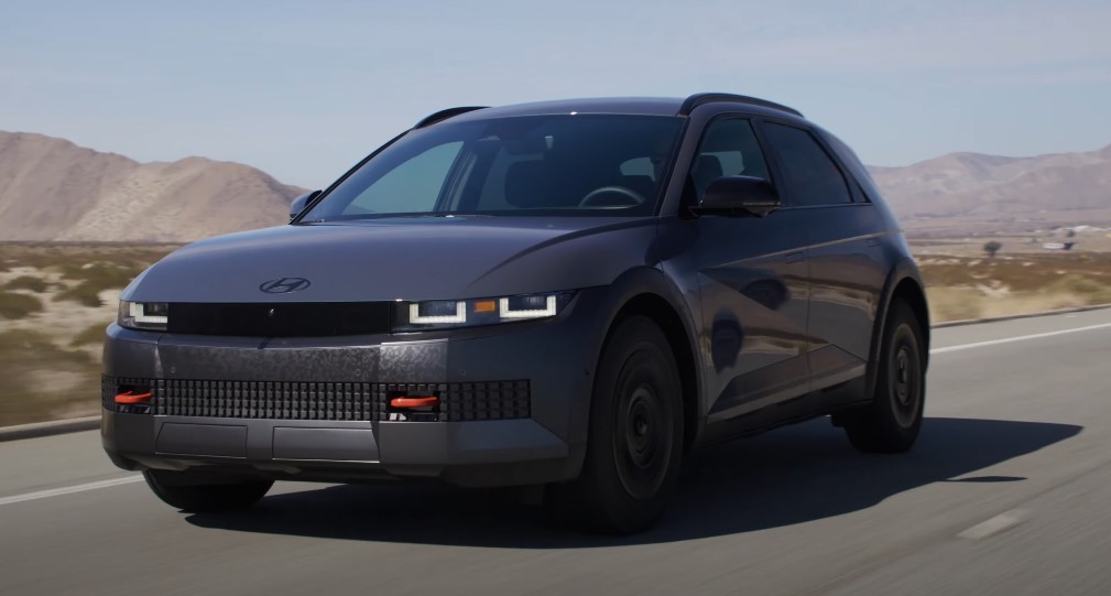 Modern Hyundai Ioniq 5 gliding across a sun-drenched highway