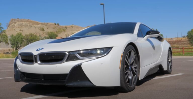 Sleek white BMW i8 parked in a sunny lot