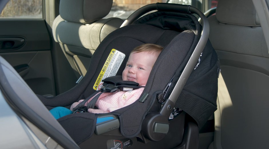 Infant securely fastened in a car seat