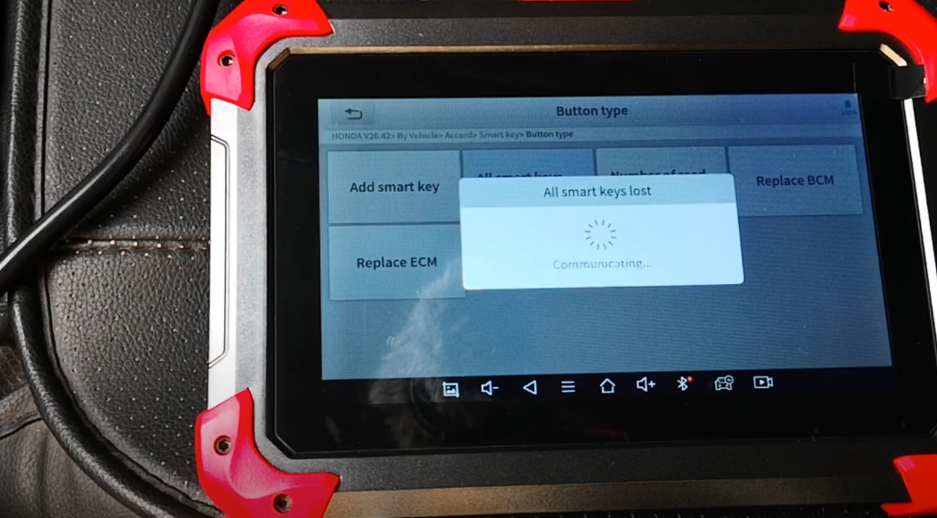 A diagnostic tablet displays options for adding a smart key