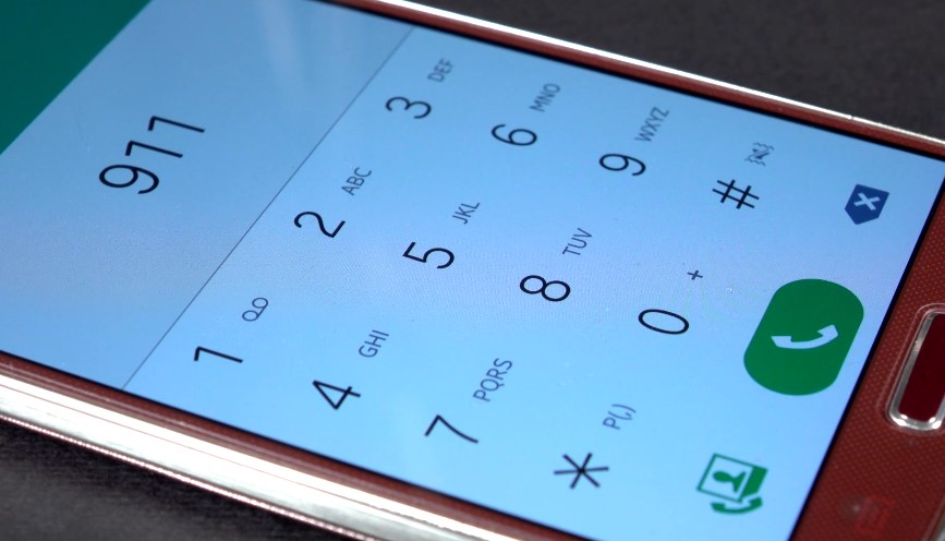 A smartphone's keypad displays the emergency number 911