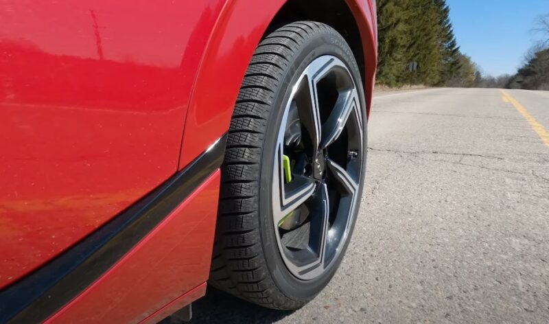 A close-up view of a tire on a red car