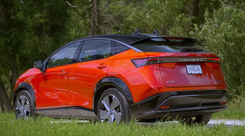 Nissan Ariya parked amidst verdant foliage