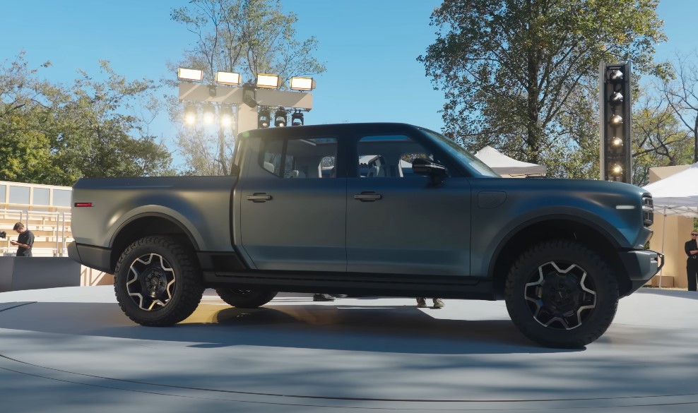 The Scout Terra, a new electric pickup truck, showcased on a stage under bright lights