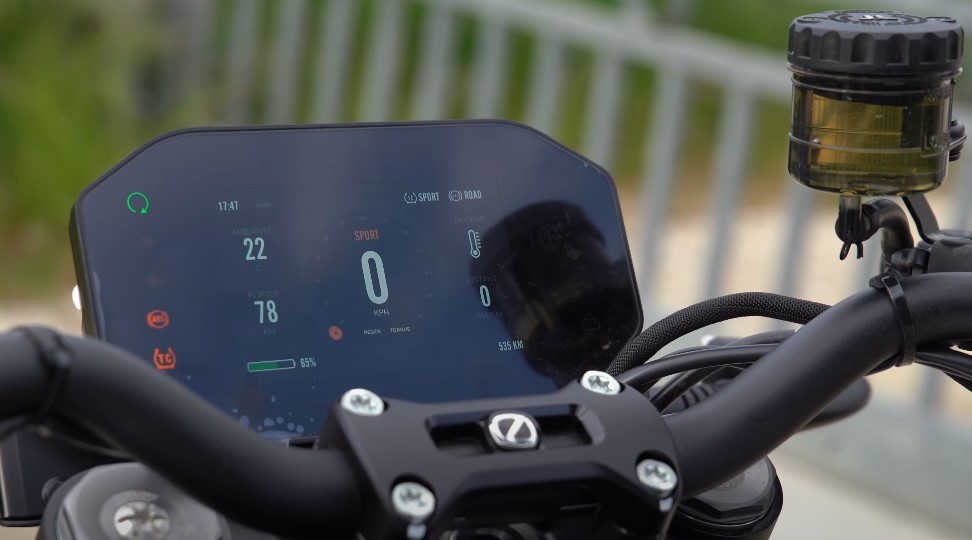 A motorcycle's digital dashboard displays the time