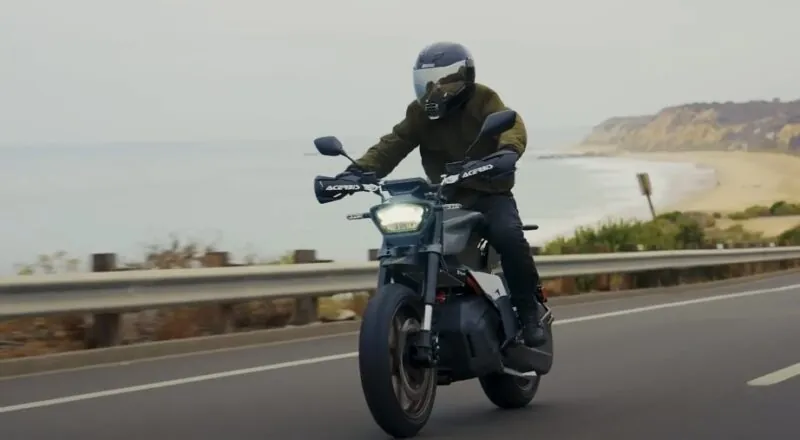 Motorcyclist navigates a coastal highway