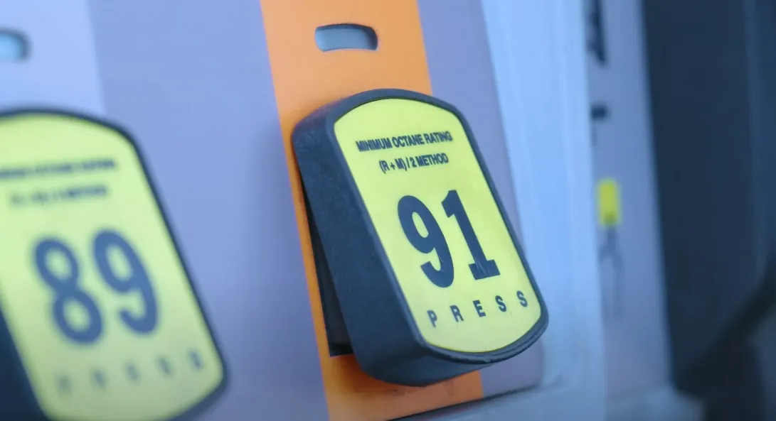 A close-up of a gas pump's octane rating display, showing 91