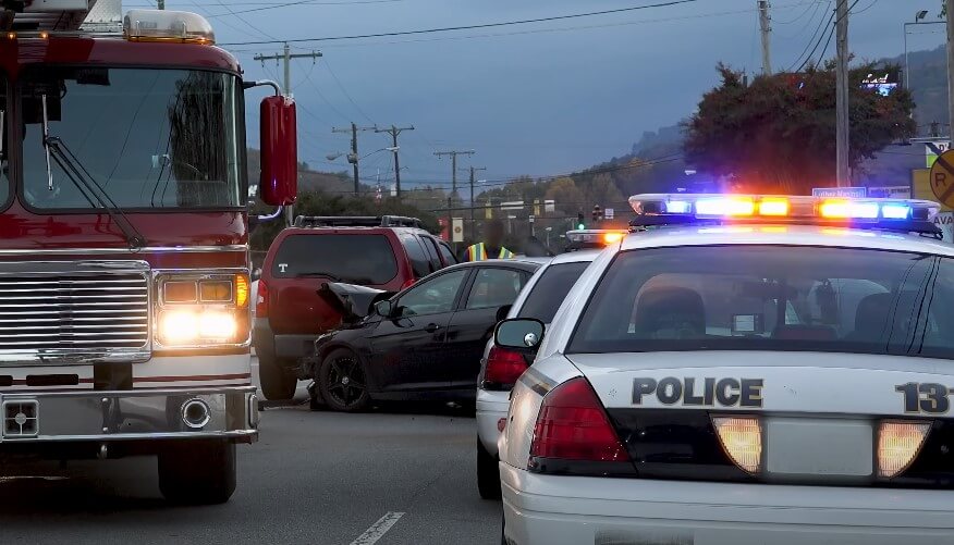 Emergency vehicles respond to a multi-vehicle accident on a city street