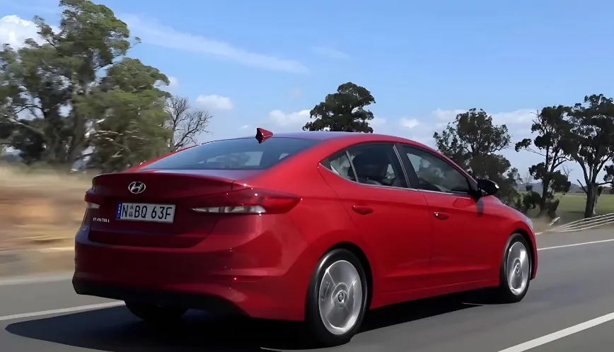 Red Hyundai Elantra, captured in motion