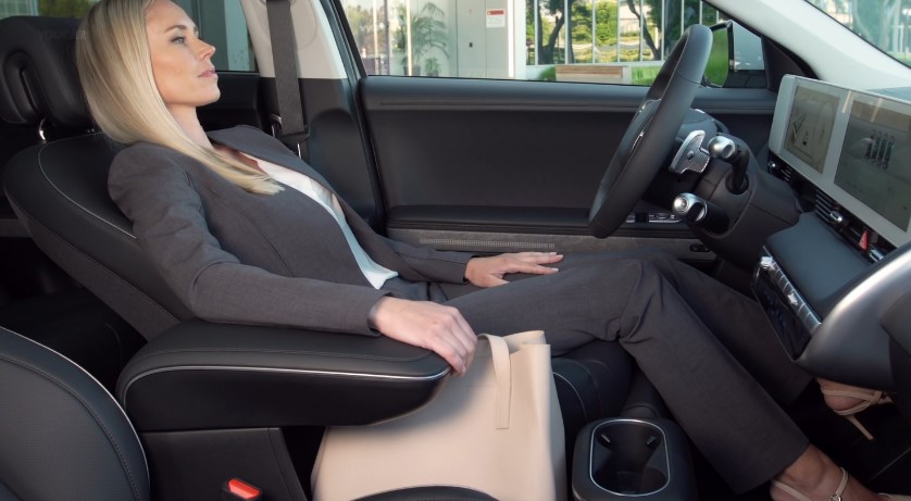 Woman seated comfortably in a modern vehicle's driver's seat