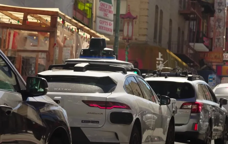 Autonomous vehicles navigate a city street