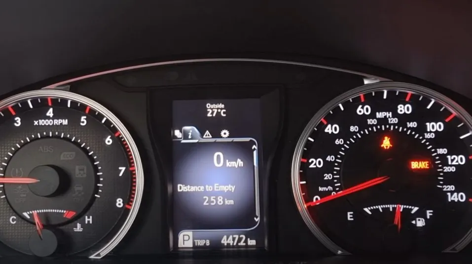 A car's instrument panel shows a current speed of zero