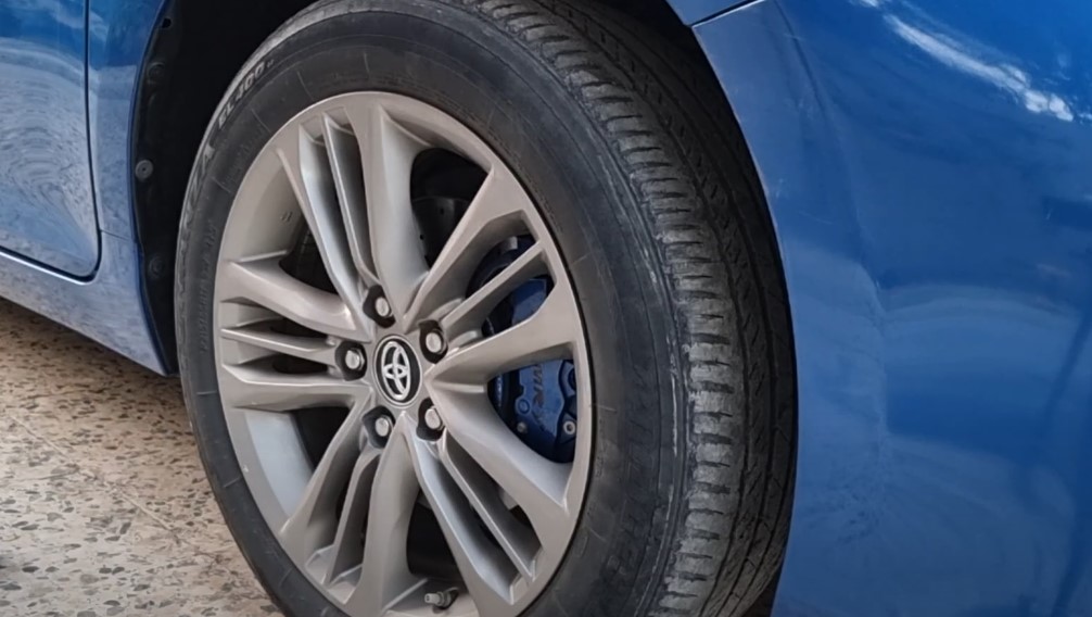 Close up of a front tire on a blue car