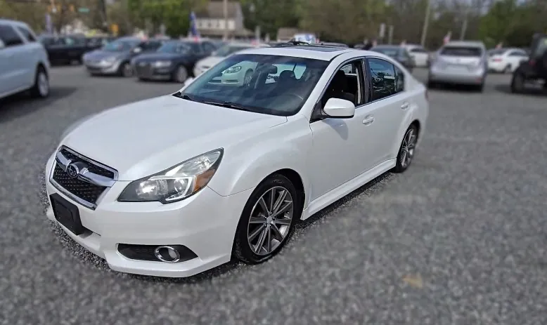 White Subaru Legacy on a parking lot