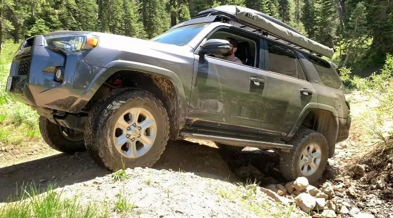 A Toyota 4Runner navigates a challenging off-road trail