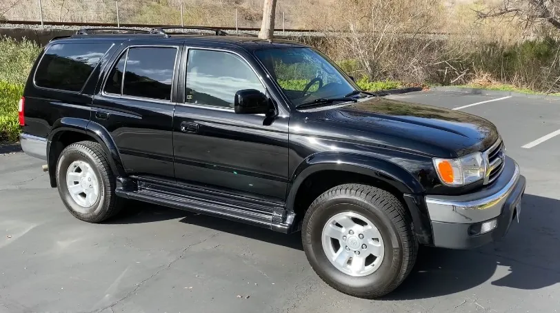 Sleek black Toyota 4Runner, parked on a paved surface