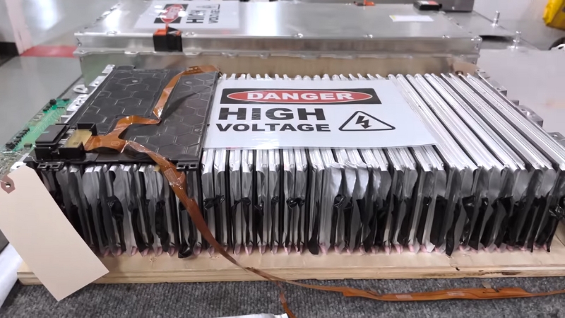 High-voltage battery pack for an electric vehicle labeled with a danger warning sign for high voltage